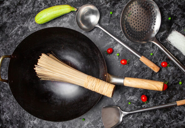 Complete cookware set for beginners with essential pots and pans arranged on kitchen counter