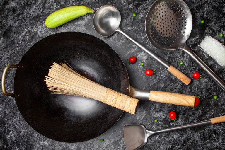 Complete cookware set for beginners with essential pots and pans arranged on kitchen counter