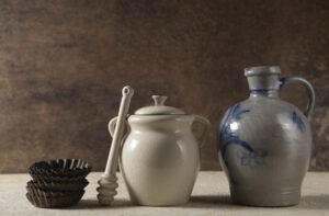 Ceramic cookware set with colorful nonstick pots and pans on kitchen counter