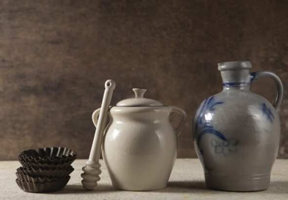 Ceramic cookware set with colorful nonstick pots and pans on kitchen counter