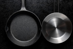 Hard-anodized vs stainless steel cookware comparison – two pans side by side